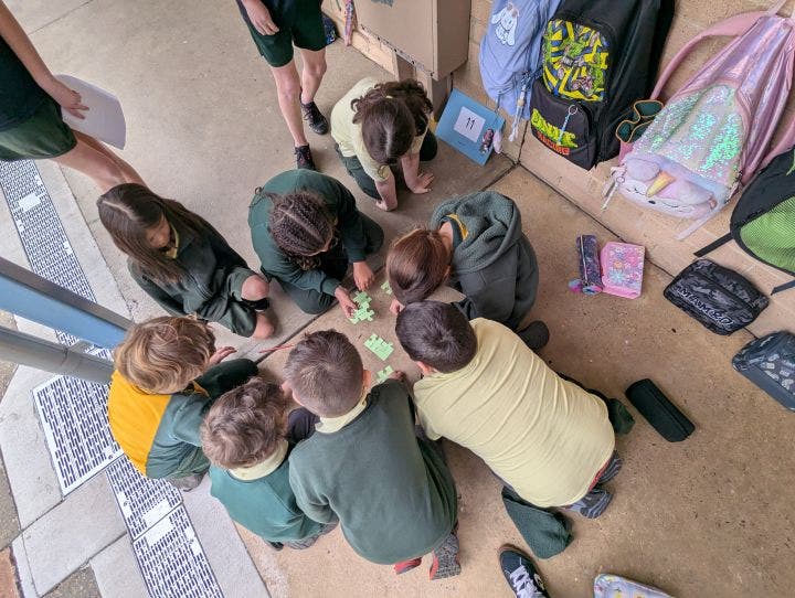 8 students playing a game on the ground