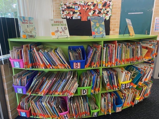 a bright green shelf of library books