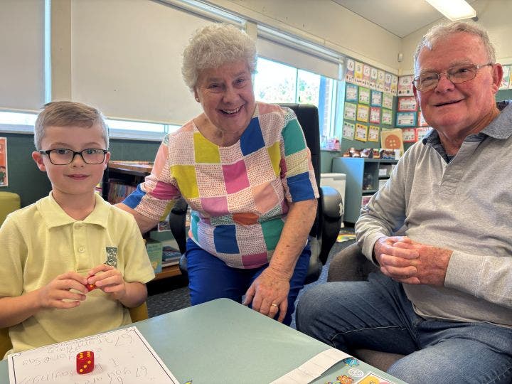 a year 1 boy with his grandparents on grandparents day