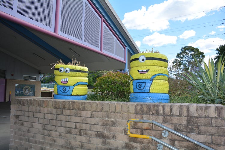 2 minions made of painted tyres in the garden
