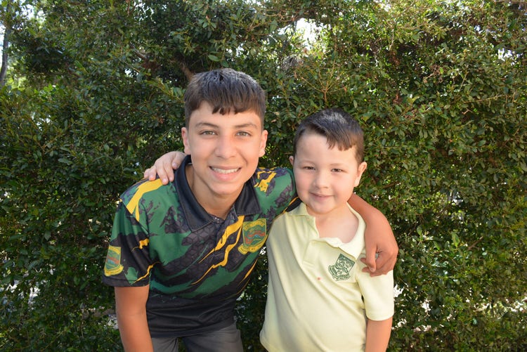 a year 6 boy with his kindy buddy