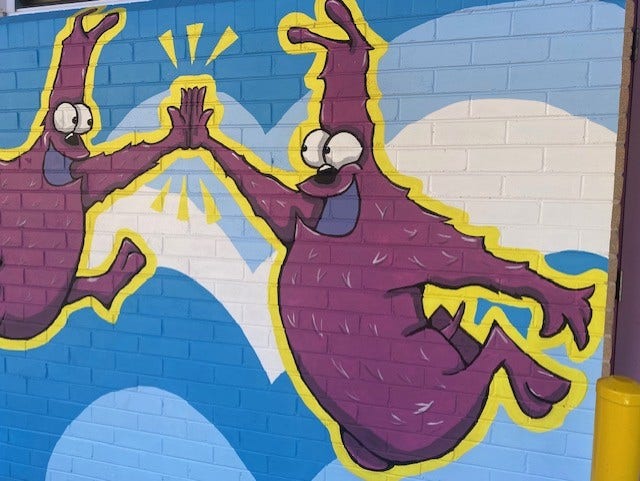 mural of 2 purple creatures named Claude