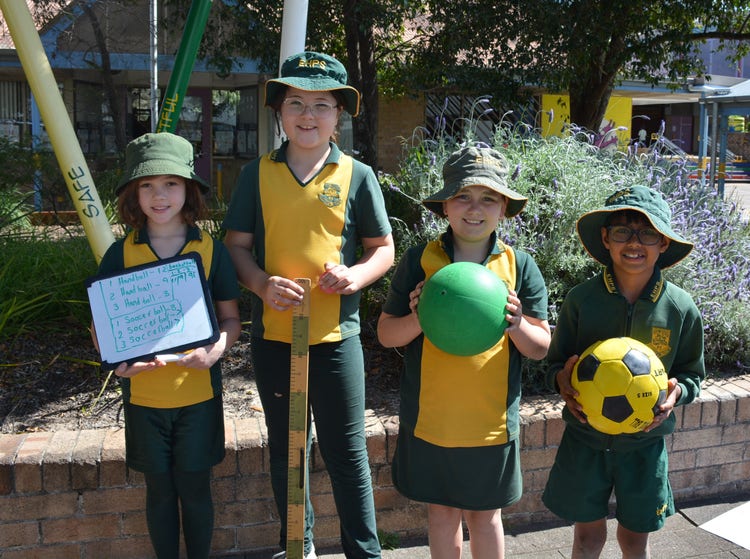 4 students completing maths activities outside