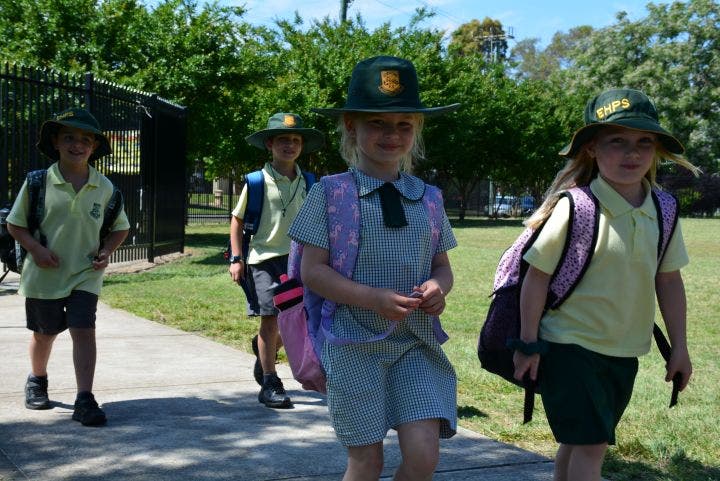 4 kindergarten students walking into the school